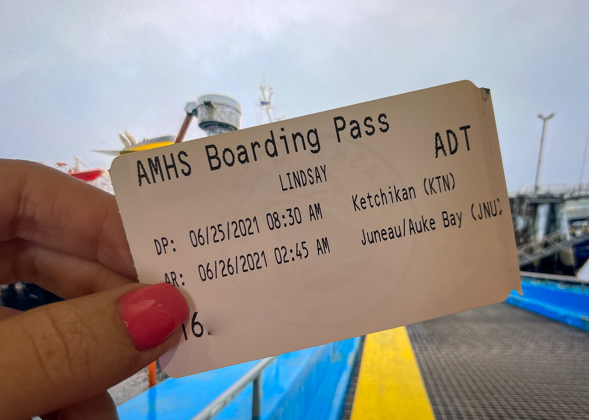 A ticket to ride the Alaska Ferry with the MV Matanuska in the background.